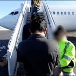 An ICE detainee boards a flight to Guatemala earlier this year. Deportation flights from the Los Angeles region have more than doubled recently. (DHS Video)