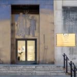 Voice of America headquarters entrance in Washington DC showing art deco relief sculpture and gold VOA sign.
