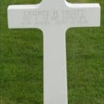 White marble cross grave marker for Technician Fourth Class George H Pruitt at Netherlands American Cemetery Margraten Plot L Row 4 Grave 4