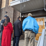 Four members of Congress entering Broadview ICE processing center in Illinois, boarded windows visible on either side of entrance