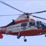 U.S. Coast Guard MH-65 Dolphin rescue helicopter in flight over Newport, Oregon