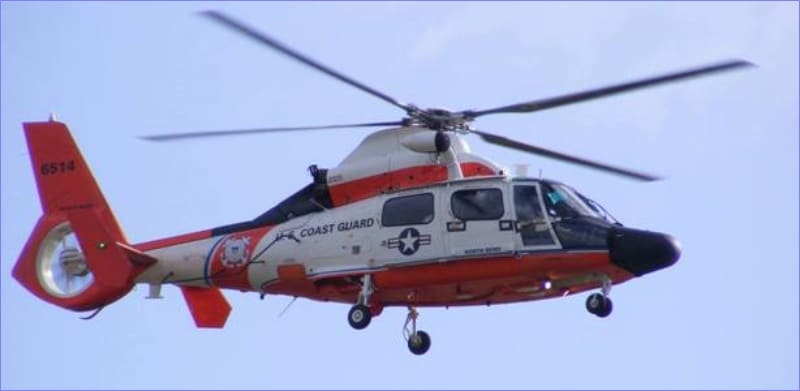 U.S. Coast Guard MH-65 Dolphin rescue helicopter in flight over Newport, Oregon