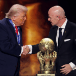 President Donald Trump shakes hands with FIFA President Gianni Infantino next to golden FIFA Peace Prize trophy at 2026 World Cup draw ceremony