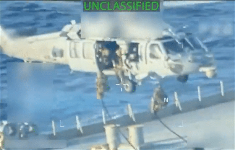 U.S. military personnel rappel from helicopter onto deck of Venezuelan oil tanker during seizure operation, marked UNCLASSIFIED