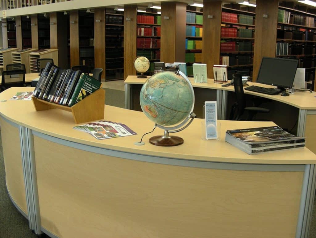 Goddard Space Flight Center library reference desk with globe and bookshelves