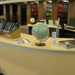 Goddard Space Flight Center library reference desk with globe and bookshelves