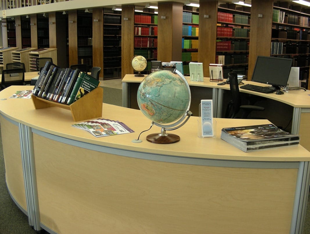 Goddard Space Flight Center library reference desk with globe and bookshelves