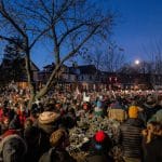 Large crowd gathers at dusk in South Minneapolis neighborhood for vigil honoring Renee Good, killed by ICE agent on January 7, 2026