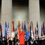 Renée Fleming in red gown performs with U.S. Naval Academy Glee Club at Lincoln Memorial during Obama inaugural ceremonies January 2009