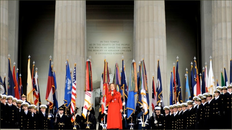 Renée Fleming in red gown performs with U.S. Naval Academy Glee Club at Lincoln Memorial during Obama inaugural ceremonies January 2009