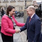 Senator Chris Coons shakes hands with Greenlandic parliamentarian Aaja Chemnitz in Copenhagen, Denmark