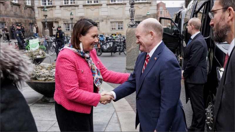 Senator Chris Coons shakes hands with Greenlandic parliamentarian Aaja Chemnitz in Copenhagen, Denmark