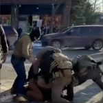 Bystander video frame showing multiple federal agents pinning Alex Pretti to the ground in Minneapolis on January 24, 2026, moments before he was shot and killed