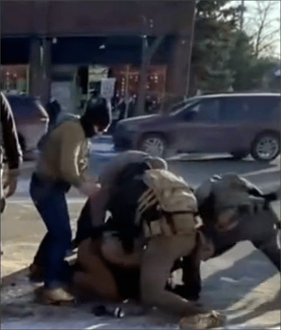 Bystander video frame showing multiple federal agents pinning Alex Pretti to the ground in Minneapolis on January 24, 2026, moments before he was shot and killed