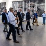 Chilean President Jose Antonio Kast walks past crowded prison cells during a tour of CECOT mega-prison in El Salvador in January 2026