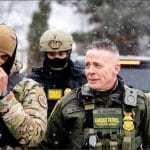 Border Patrol Commander Greg Bovino with BORTAC officers at a Minneapolis gas station, January 2026