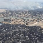 Aerial view of the Morrill Fire showing scorched grazing land and smoke across Nebraska on March 14, 2026
