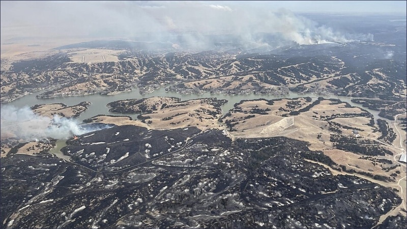 Aerial view of the Morrill Fire showing scorched grazing land and smoke across Nebraska on March 14, 2026