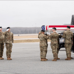 Army carry team loads flag-draped transfer case at Dover Air Force Base dignified transfer for soldiers killed in Kuwait during Iran war, March 2026