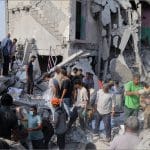 Rescue workers and civilians dig through rubble of destroyed Shajareh Tayyebeh girls school in Minab Iran after US airstrike
