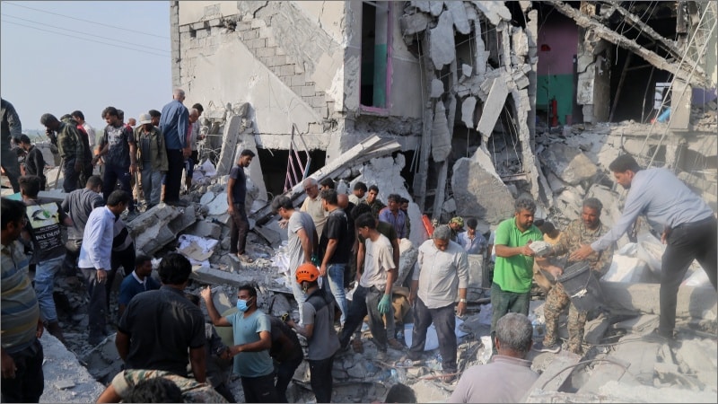 Rescue workers and civilians dig through rubble of destroyed Shajareh Tayyebeh girls school in Minab Iran after US airstrike