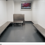 DHS immigration holding room with metal benches and no beds at a port of entry, photographed by the Government Accountability Office