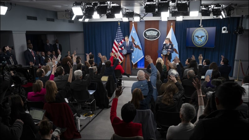 Secretary of Defense Pete Hegseth and Joint Chiefs Chairman Gen. Dan Caine conduct a Pentagon press briefing on Operation Epic Fury as reporters raise their hands to ask questions, March 2, 2026.