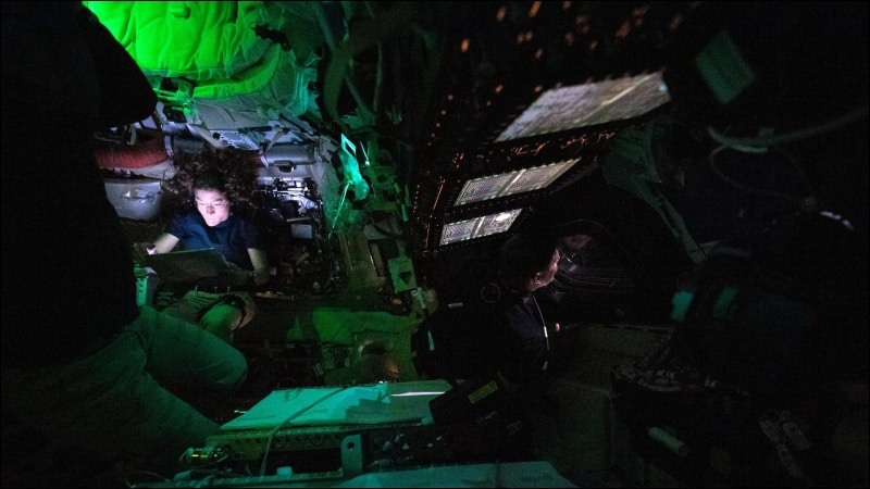 NASA astronaut Christina Koch illuminated by a screen inside the Orion spacecraft during the Artemis II lunar flyby mission, April 2026
