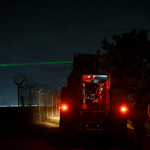 U.S. Air Force Zeus III high-energy laser fires at a drone target at night during Exercise Freedom Shield 26 at Kunsan Air Base, South Korea