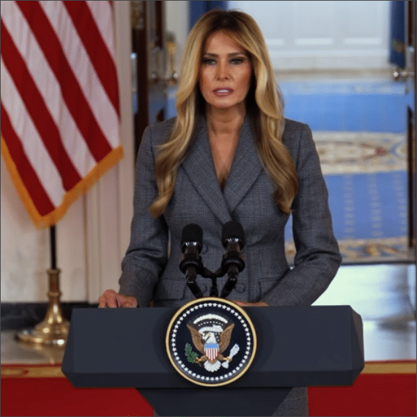 First Lady Melania Trump speaks behind the presidential seal podium in the White House Grand Foyer