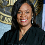 U.S. District Judge Eleanor L. Ross in her judicial robe before the seal of the Northern District of Georgia
