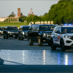 Trump motorcade driving through the drained Lincoln Memorial Reflecting Pool with the Washington Monument in the background