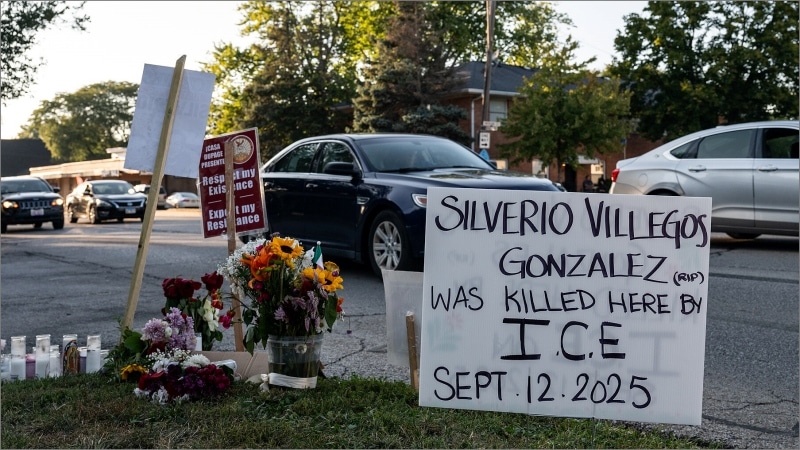 Roadside memorial with flowers, candles, and a handwritten sign reading "Silverio Villegos Gonzalez was killed here by I.C.E. Sept. 12. 2025" in Franklin Park, Illinois.