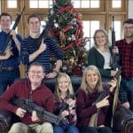 Rep. Thomas Massie and family posing with rifles in their 2021 Christmas card photo