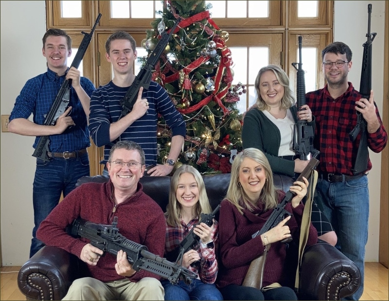 Rep. Thomas Massie and family posing with rifles in their 2021 Christmas card photo