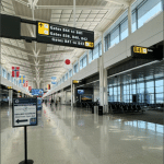 Dulles International Airport international concourse with global flags hanging from the ceiling
