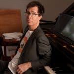 Ben Folds, former National Symphony Orchestra artistic adviser, seated beside a grand piano