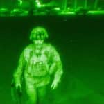 Green night-vision photo of Gen. Chris Donahue walking to a C-17, the last American soldier to leave Afghanistan, Kabul, 2021