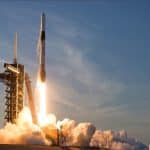 A SpaceX Falcon 9 rocket lifts off from a launch pad at Kennedy Space Center, Florida