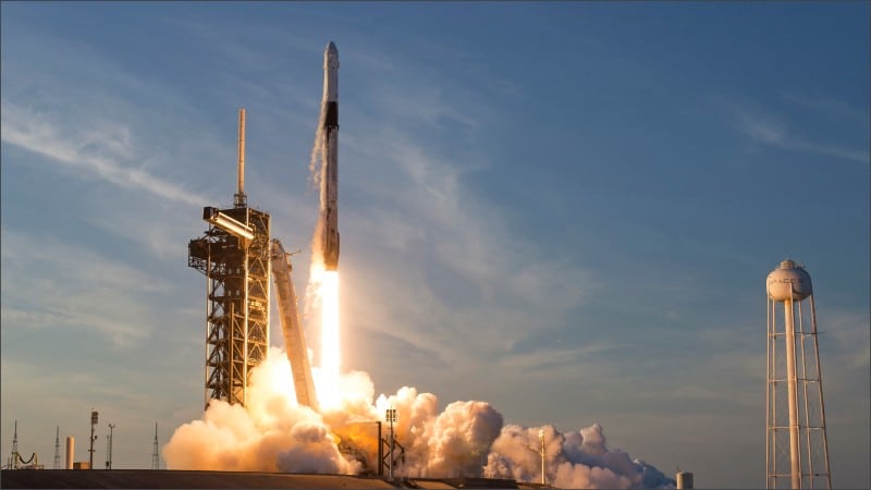 A SpaceX Falcon 9 rocket lifts off from a launch pad at Kennedy Space Center, Florida