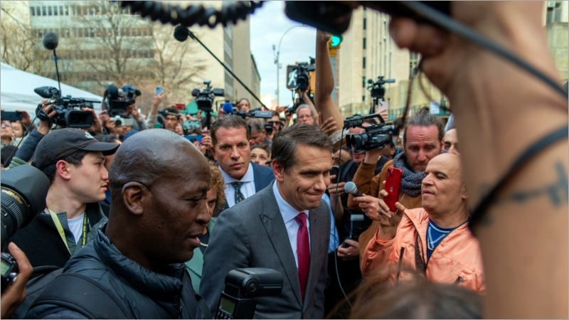 Todd Blanche surrounded by reporters outside Manhattan Criminal Courthouse in 2023