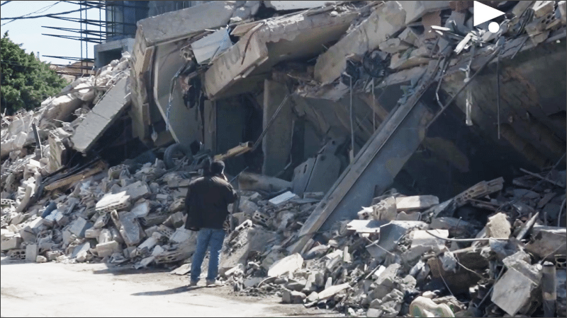 Man standing alone before the rubble of a collapsed building after Israeli airstrikes in the Bachoura neighborhood of Beirut, Lebanon