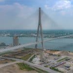 Aerial view of the Gordie Howe International Bridge cable-stayed span crossing the Detroit River between Detroit and Windsor before its July 2026 opening