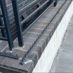 Metal spikes installed on a brick ledge in Washington DC, hostile architecture designed to prevent people from sitting or resting