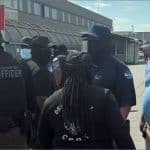 Masked GEO Group transport officers outside Delaney Hall ICE detention facility in Newark
