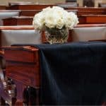 Black-draped Senate desk of the late Sen. Lindsey Graham with white roses