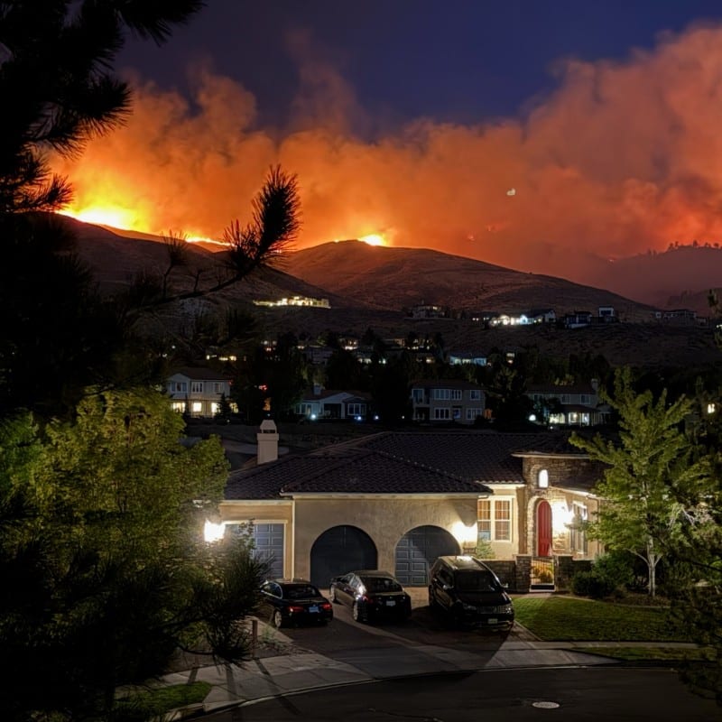 Hawk Fire glows on ridge above Reno homes at night