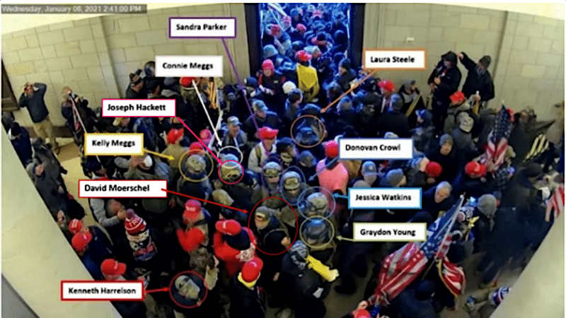 Capitol security camera image from January 6, 2021, with labels identifying ten Oath Keepers members and associates in the crowd inside the building