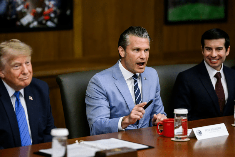 Defense Secretary Pete Hegseth speaks next to a smiling President Donald Trump during a Camp David cabinet meeting on July 31, 2026.