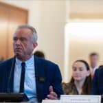Health Secretary Robert F. Kennedy Jr. and CMS Administrator Mehmet Oz seated at a Healthcare Advisory Committee meeting